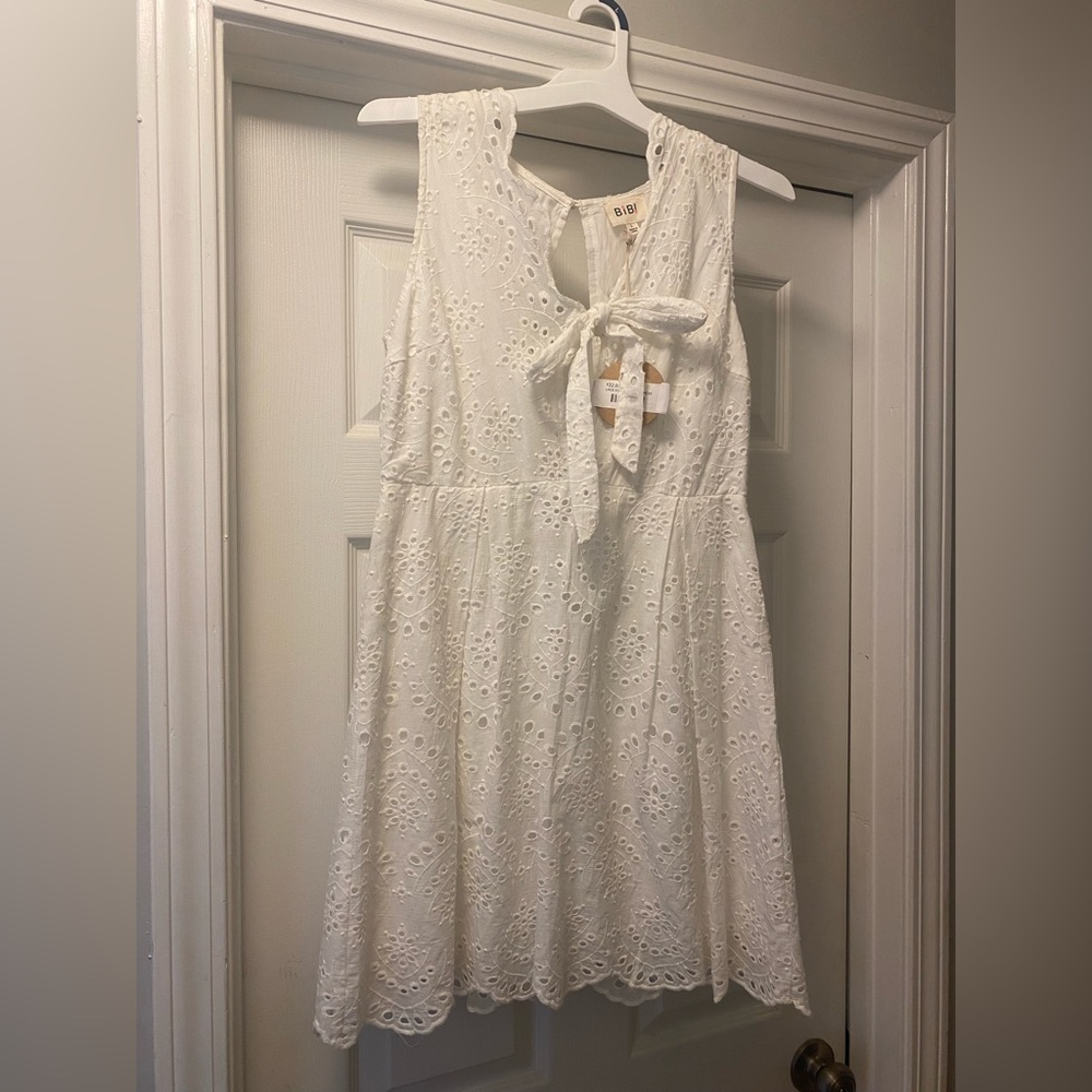 White boutique style dress with tie front. NWT, never worn.